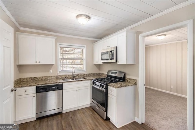 kitchen with white cabinets, stainless steel appliances, dark colored carpet, dark stone countertops, and sink