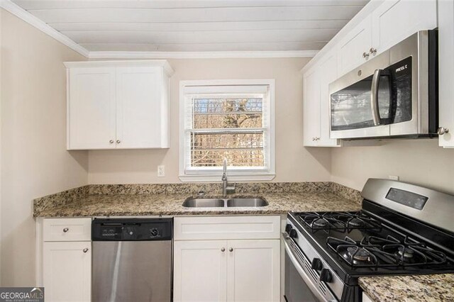 kitchen with stainless steel appliances, white cabinetry, and sink