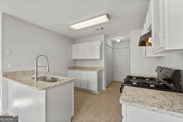 kitchen featuring white cabinetry, light stone countertops, a textured ceiling, black range with gas cooktop, and sink