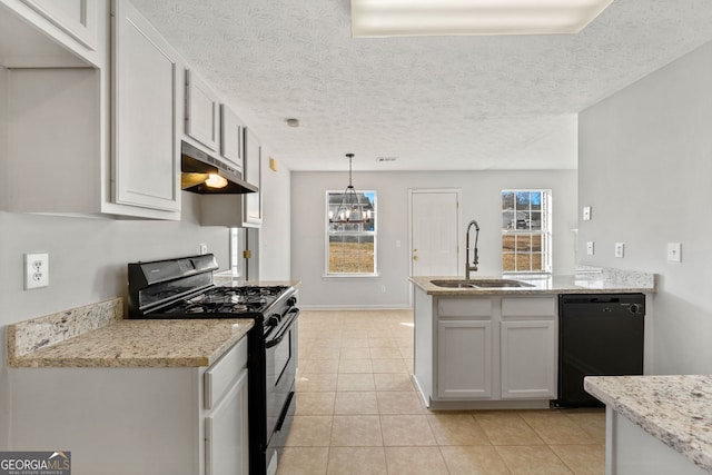 kitchen featuring black appliances, sink, hanging light fixtures, light tile patterned floors, and light stone counters