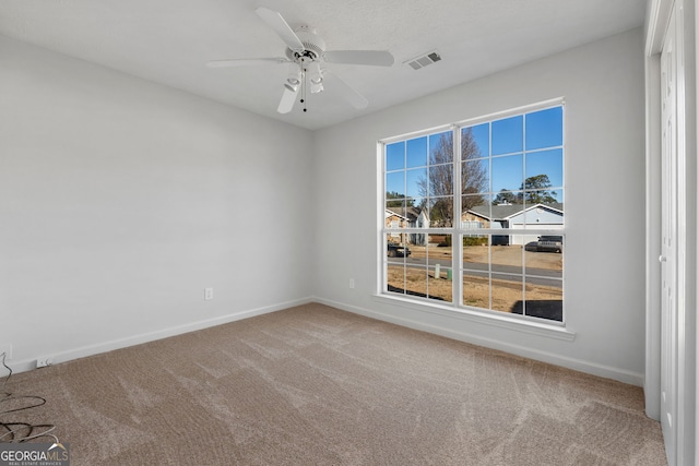 carpeted empty room with ceiling fan