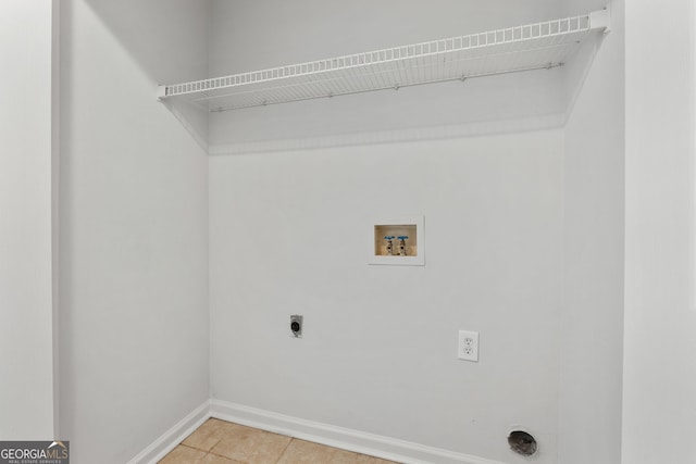 laundry room featuring hookup for a washing machine, electric dryer hookup, and tile patterned flooring