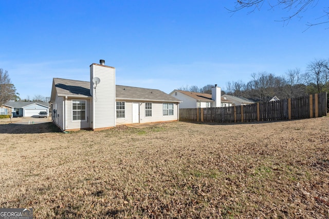 rear view of house with a lawn