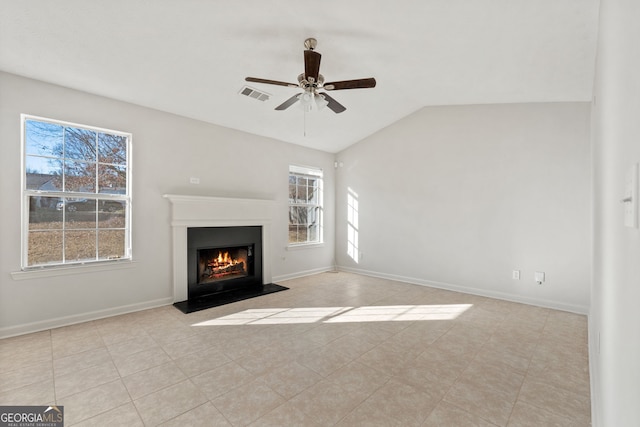 unfurnished living room with lofted ceiling, ceiling fan, plenty of natural light, and light tile patterned flooring