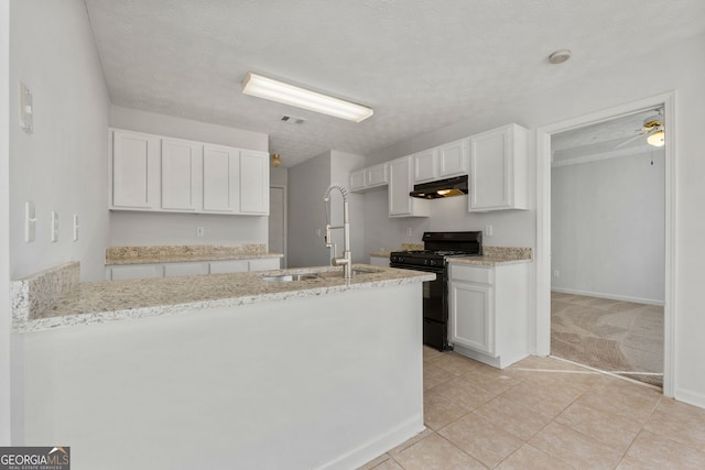 kitchen with sink, white cabinetry, and black gas range oven