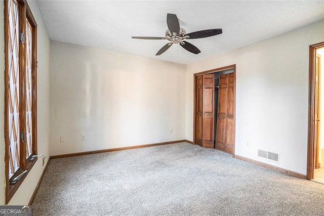 unfurnished bedroom featuring ceiling fan, carpet, and a closet