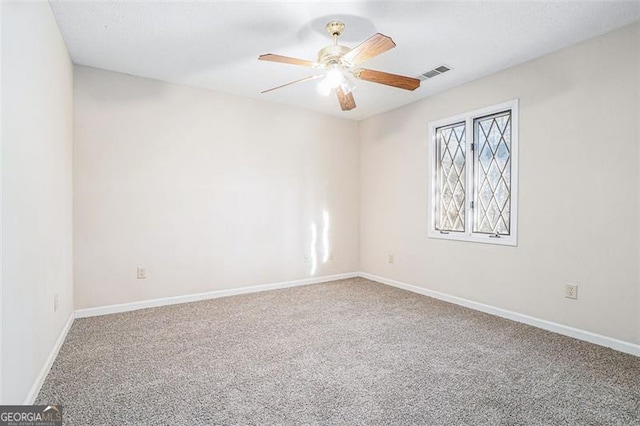 spare room with carpet floors and ceiling fan