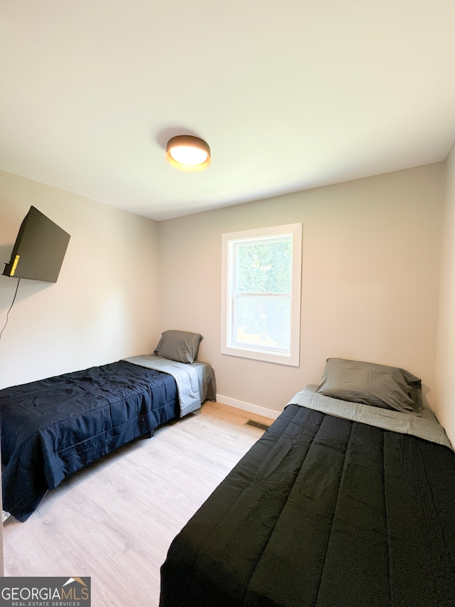 bedroom with light hardwood / wood-style flooring