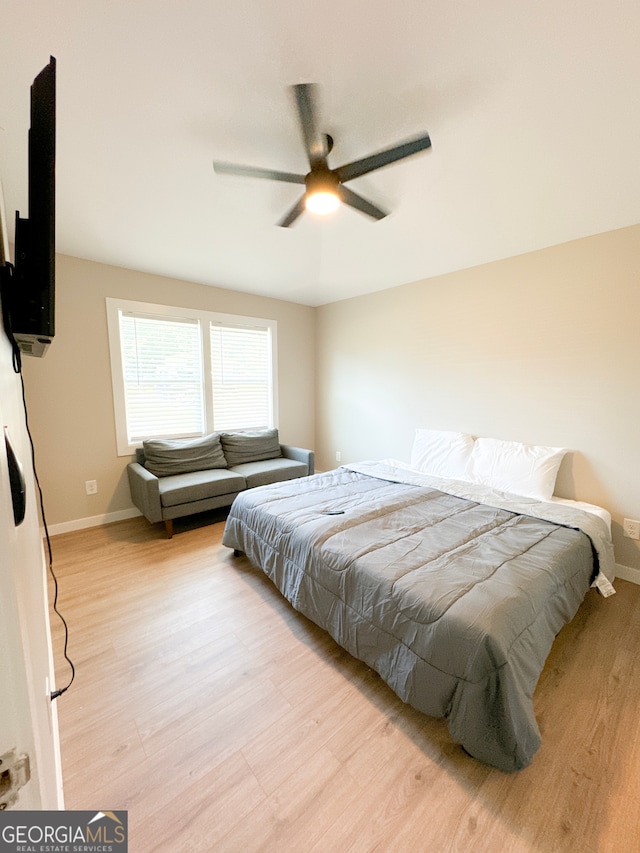 bedroom with ceiling fan and light hardwood / wood-style flooring