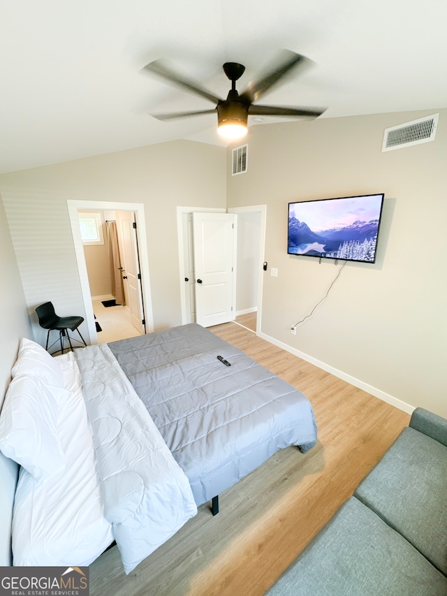 bedroom with ceiling fan, hardwood / wood-style flooring, and lofted ceiling