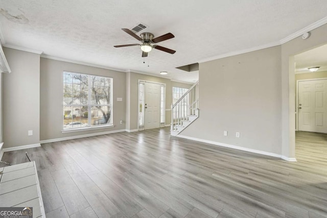 unfurnished living room with a textured ceiling, ceiling fan, crown molding, and wood-type flooring