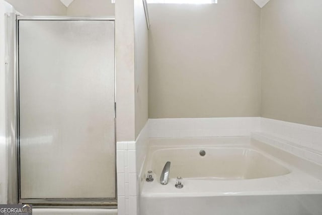 bathroom featuring separate shower and tub