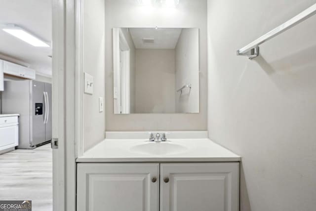 bathroom with vanity and wood-type flooring