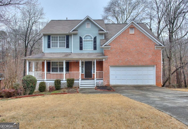 view of front property with a garage, a front yard, and covered porch