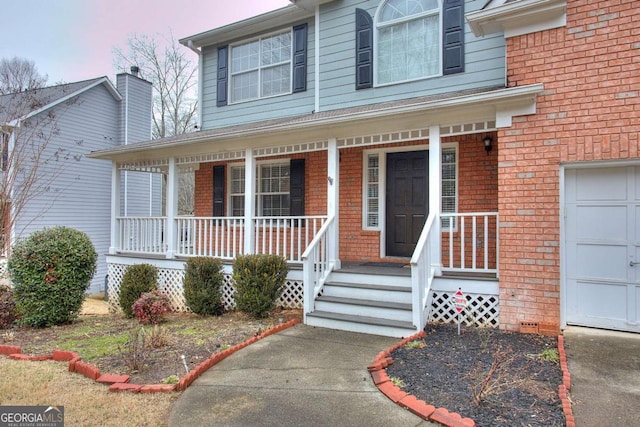 view of front of house with covered porch and a garage