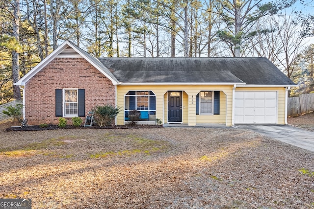 ranch-style home featuring a garage and covered porch