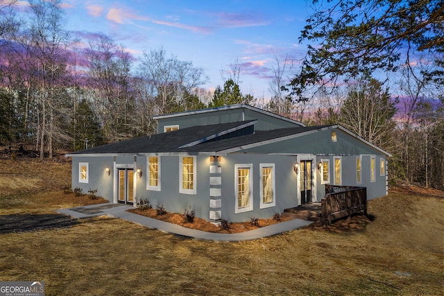 view of back house at dusk