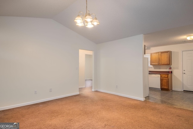 unfurnished living room with vaulted ceiling, a chandelier, and carpet flooring