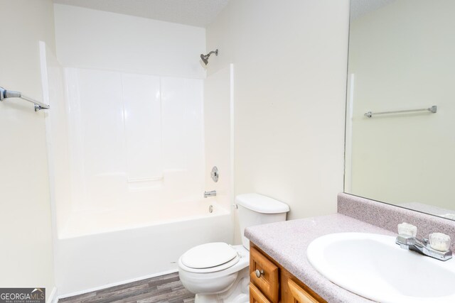 full bathroom with toilet, wood-type flooring, vanity, and shower / bathing tub combination