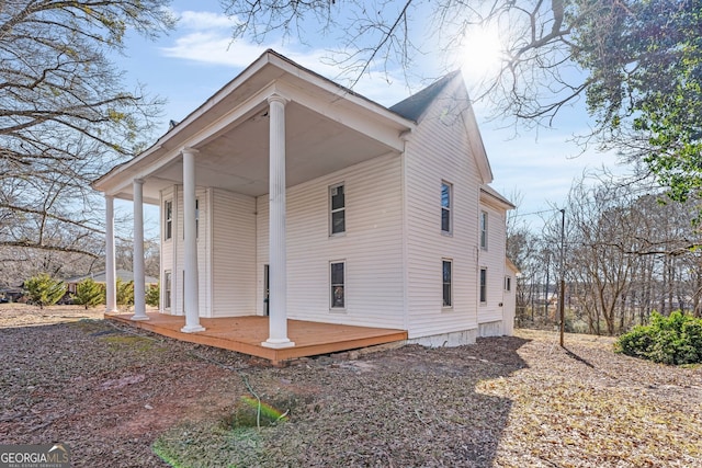 rear view of property featuring a porch