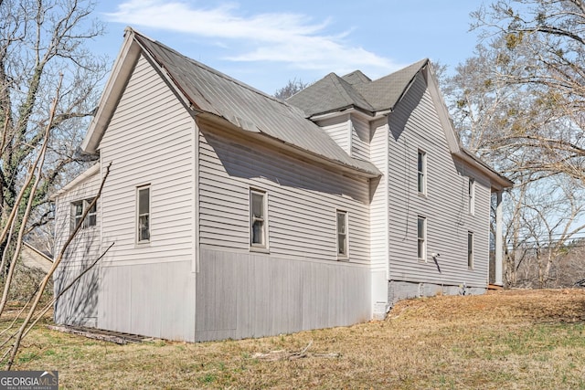 view of home's exterior with a lawn