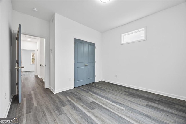 550 Paines Ave NW, Atlanta, GA 30318 - unfurnished bedroom featuring dark wood-style flooring and a closet