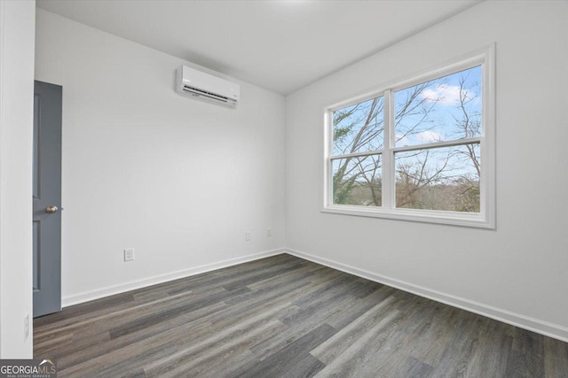 unfurnished room with dark hardwood / wood-style flooring and a wall mounted AC