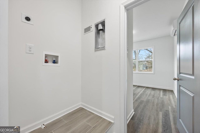 clothes washing area with hookup for an electric dryer, hookup for a washing machine, and hardwood / wood-style flooring