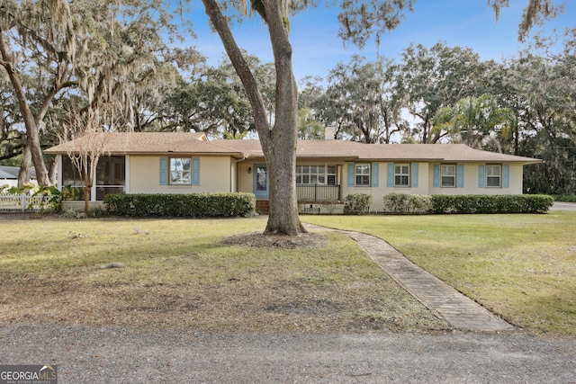 ranch-style home with a front lawn