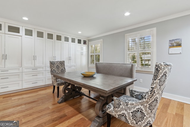 dining room featuring ornamental molding and light hardwood / wood-style flooring