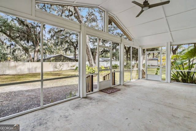 unfurnished sunroom with lofted ceiling and ceiling fan