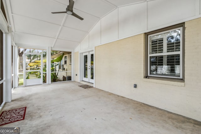 unfurnished sunroom with vaulted ceiling and ceiling fan