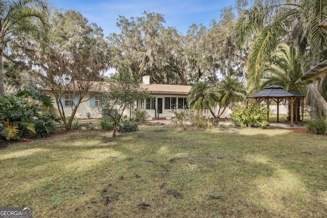 view of front of property featuring a gazebo and a front yard