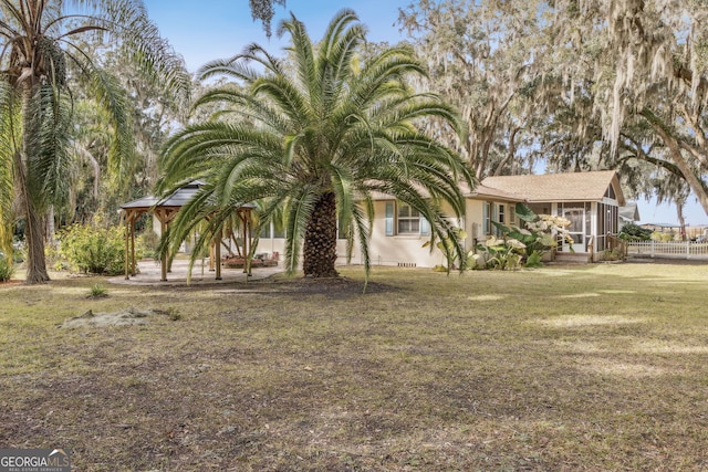 exterior space with a gazebo and a sunroom