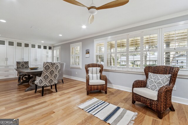 sitting room featuring ornamental molding, ceiling fan, and light wood-type flooring