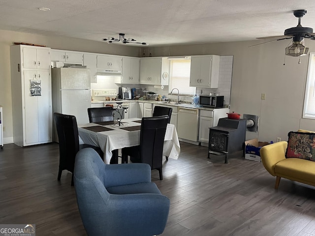 kitchen featuring white cabinetry, dark hardwood / wood-style floors, sink, and white appliances