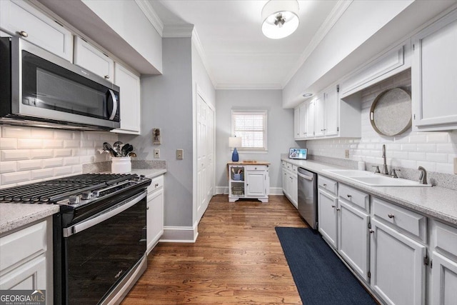 kitchen featuring white cabinetry, dark hardwood / wood-style flooring, stainless steel appliances, tasteful backsplash, and sink