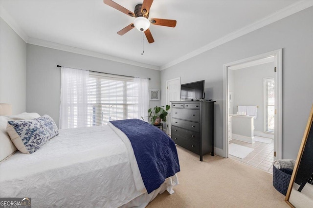 carpeted bedroom featuring ceiling fan, ensuite bathroom, and ornamental molding