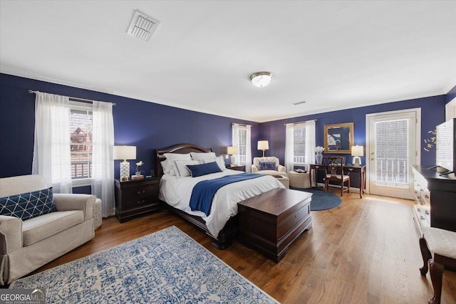 bedroom with access to exterior and dark hardwood / wood-style floors