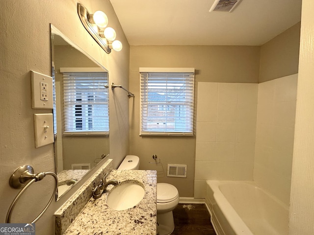 bathroom with toilet and vanity