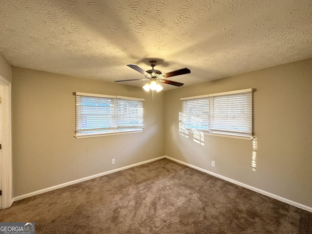 carpeted spare room with ceiling fan and a textured ceiling