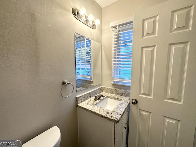 bathroom featuring toilet and vanity