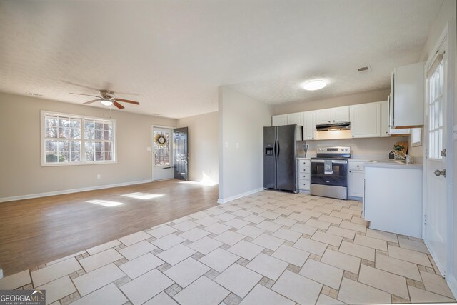 kitchen with stainless steel range with electric stovetop, black fridge with ice dispenser, sink, and white cabinets