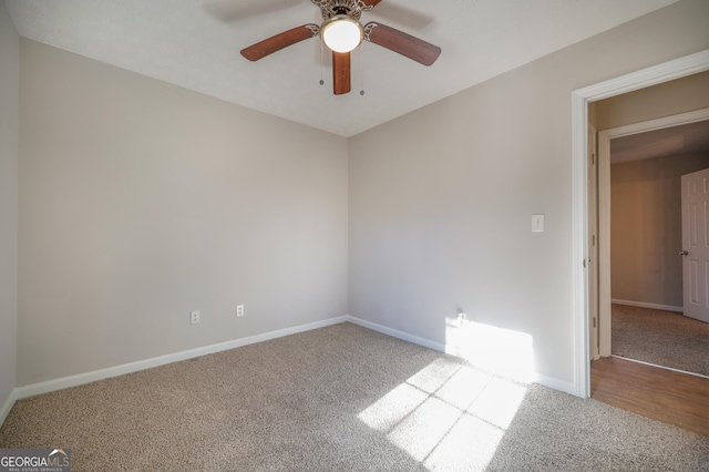 carpeted spare room with ceiling fan