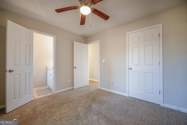 empty room featuring light carpet and ceiling fan