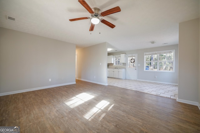 spare room with ceiling fan and light hardwood / wood-style floors