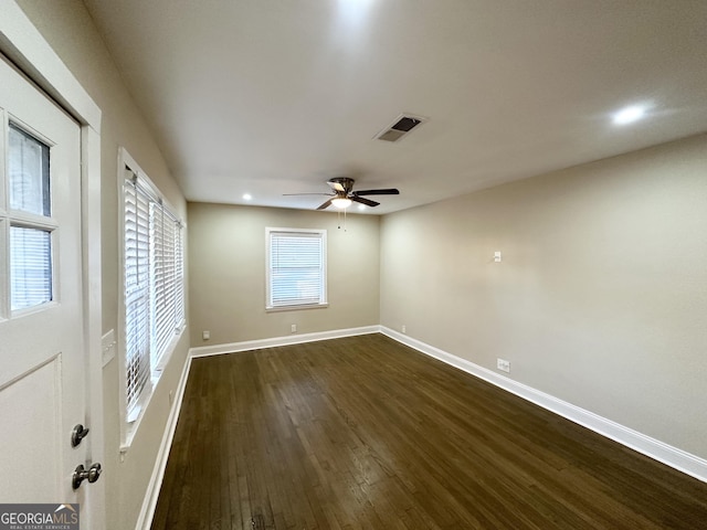 spare room with ceiling fan and dark hardwood / wood-style floors