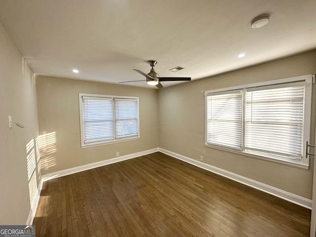 unfurnished room with ceiling fan, plenty of natural light, and dark hardwood / wood-style flooring