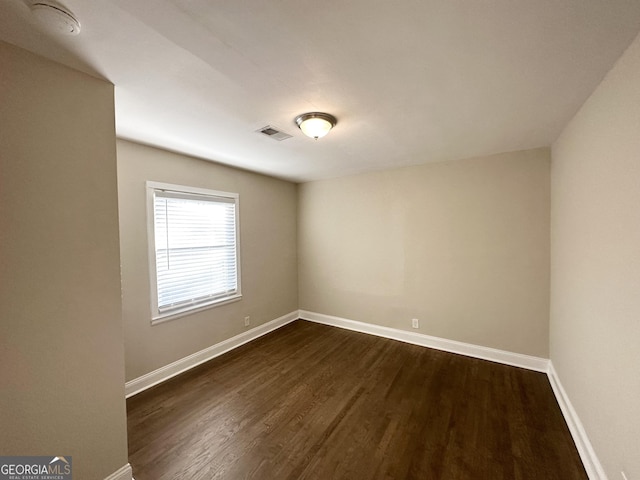 unfurnished room featuring dark hardwood / wood-style flooring