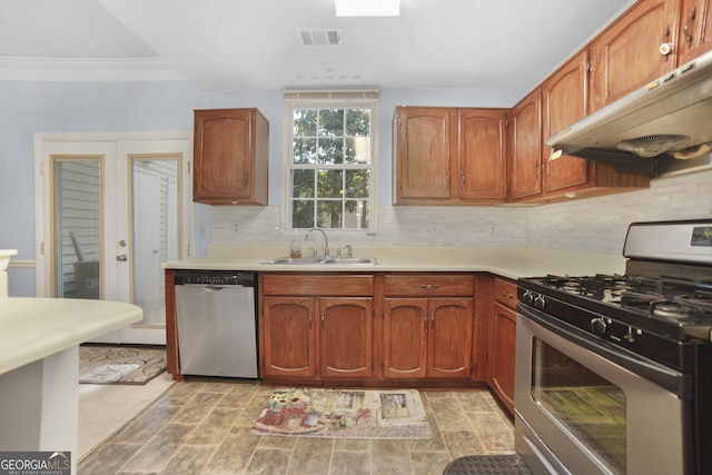 kitchen featuring tasteful backsplash, sink, crown molding, stainless steel appliances, and french doors